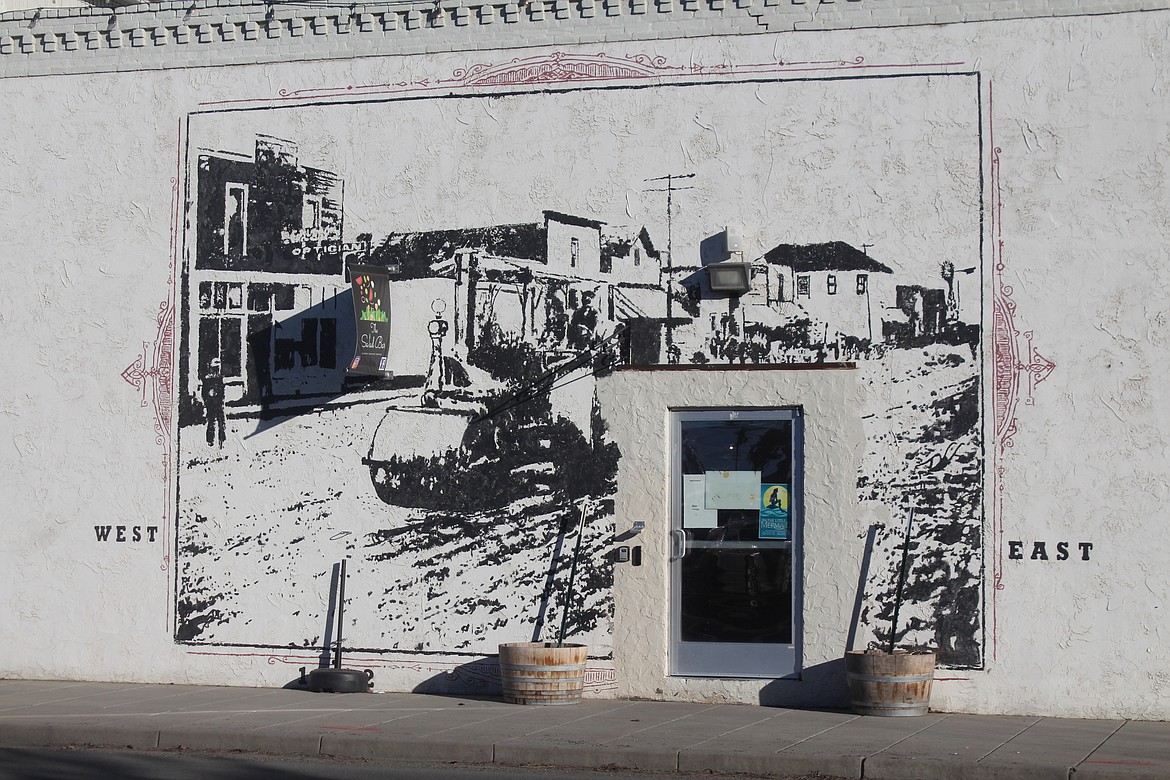 Repairing a street in old Quincy is the subject of a mural at the Salad Bar Cafe, 10 B St. SE in Quincy.