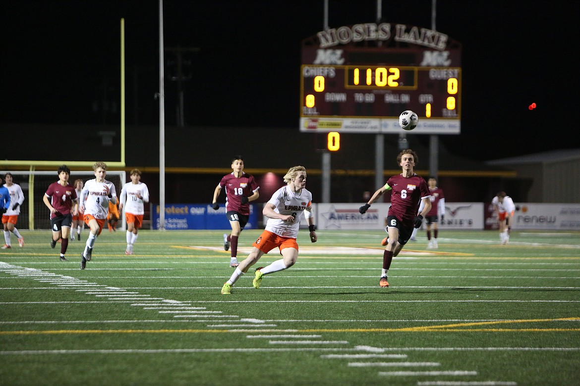 Ephrata senior Hudson Sager (6 in white) and Moses Lake junior Jackson Mohs (6 in maroon) chase after a ball in the first half of Tuesday’s matchup between the Tigers and Mavericks.