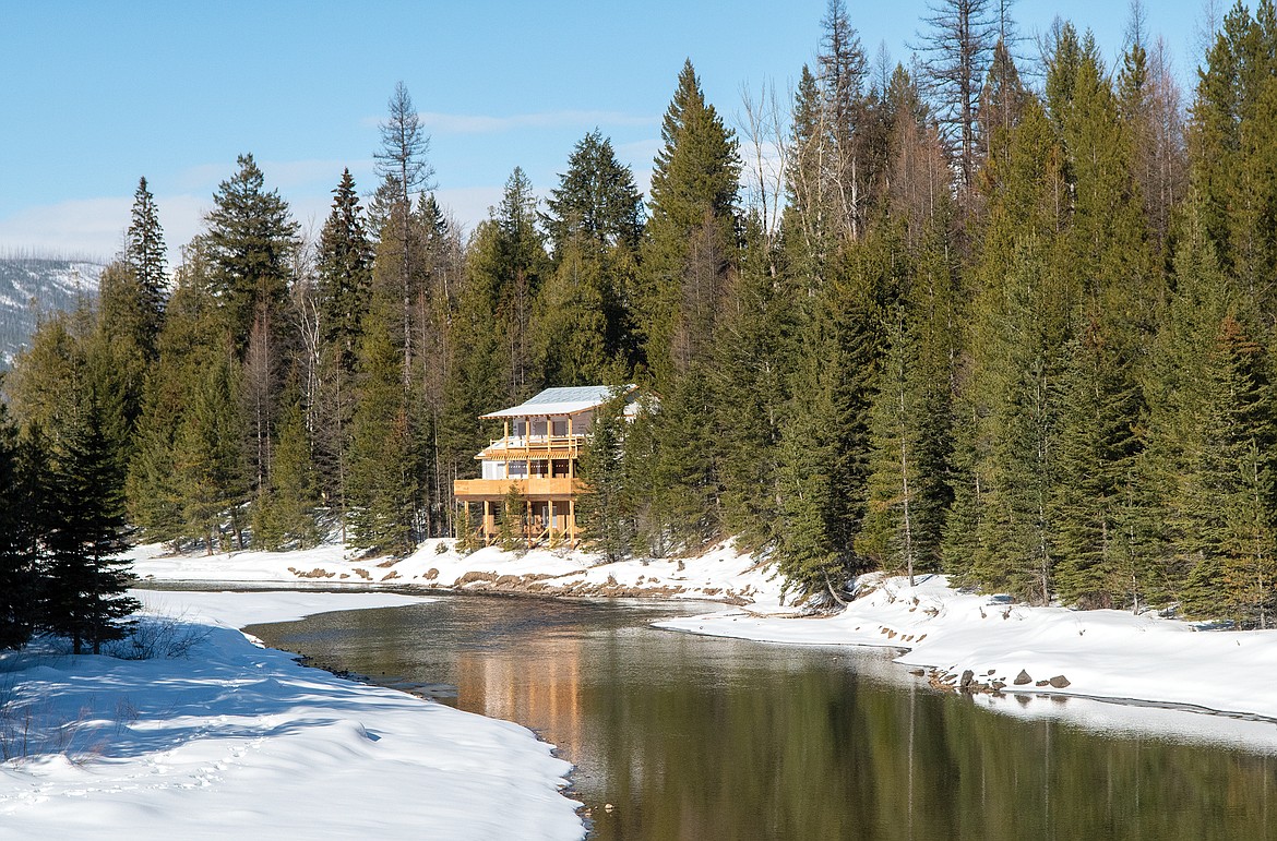 A home under construction along the banks of McDonald Creek inside Glacier National Park. (Chris Peterson/Hungry Horse News)