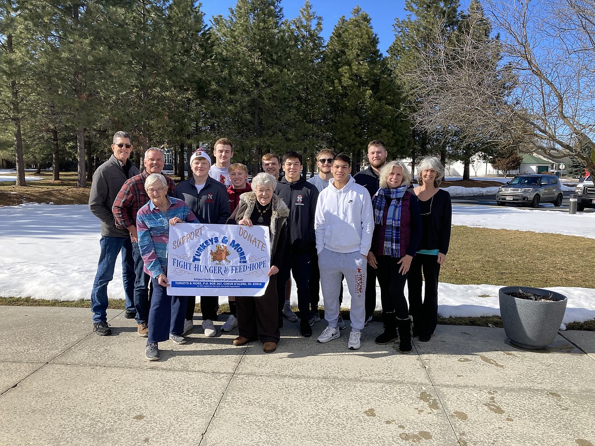 North Idaho College wrestlers, who helped with the turkey distribution, were invited to a recent meeting to be thanked for their super assistance last November. They helped pass out turkeys and grocery gift cards to about 600 vulnerable families. The Coeur Group assisted delivering the rest of the 1,800 birds to 20 food banks or social service agencies throughout Kootenai County. Founder Evalyn Adams said the Turkey Committee has been meeting since January to make sure plans are made to continue this worthwhile project. Because of a higher percentage of food insecure families this year, the nonprofit will try to purchase 2,000 turkeys for November. Turkey prices are extremely high due to bird flu, so it will be necessary to raise more than $60,000. People who want to help Fight Hunger and Feed Hope are encouraged to mail a check to Turkeys & More, P.O. Box 267, Coeur d'Alene, ID 83816. Anyone wanting to help is welcome to contact Adams at 208 765-5535 or evalynera@hotmail.com. From left in back two rows are: John Jacobs, web specialist; Bill Griffiths, treasure; NIC wrestlers: Bradley Whitright, Ethan Miller, Kobi Johnson, Travis Walker, Kana'ipano Tapia, Ledger Petracer, Brant Porter, and Cooper Thomas, assistant coach; Mayte Eriksson, secretary and Nancy Nelson, president. In front with the sign are Trish Dutoit, board member and Evalyn Adams, founder and vice president.