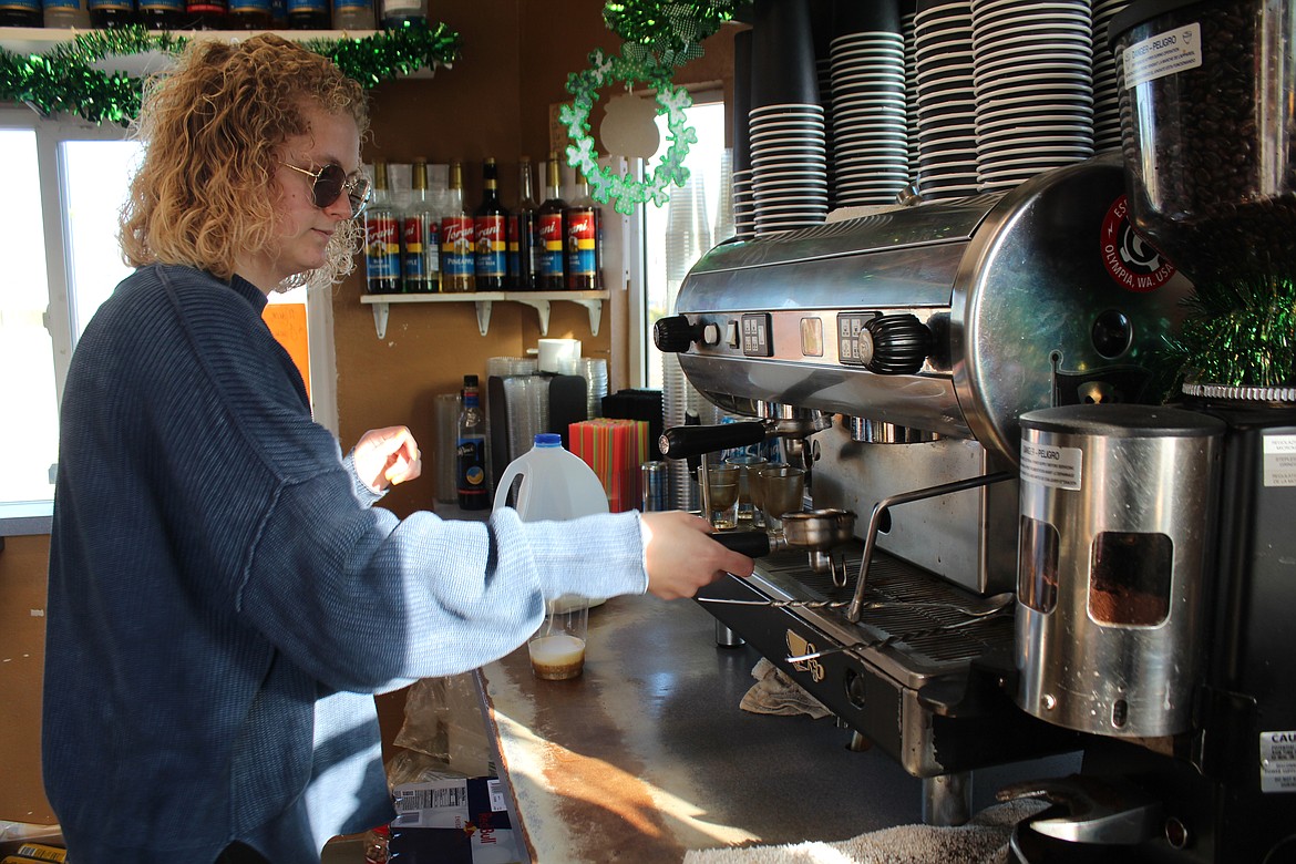 Jayden Brown, barista at Kix Stand Espresso in Othello, works on a cup of coffee for a customer.