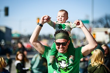 Duke Tomlinson holds his 15-month-old son Rustin on his shoulders before the start of the St. Patrick's Day Parade in Kalispell on Friday, March 17. (Casey Kreider/Daily Inter Lake)