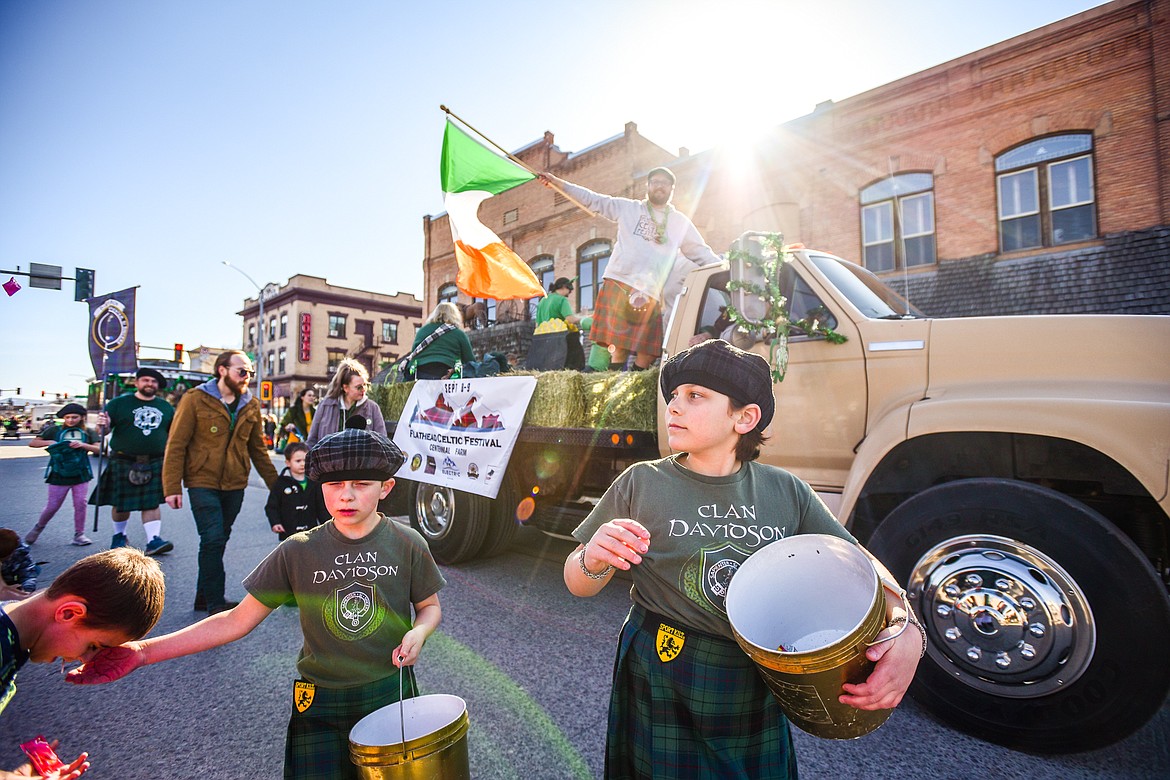 A truck with members of the Flathead Celtic Festival rolls down Main Street during the St. Patrick's Day Parade in Kalispell on Friday, March 17. (Casey Kreider/Daily Inter Lake)