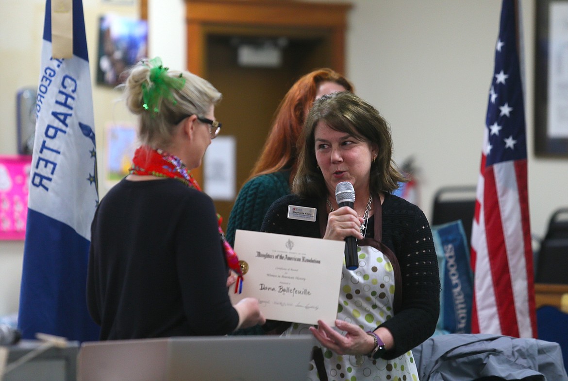 Daughters of the American Revolution Lt. George Farragut Chapter American History Committee Chair Stephanie Keaty on Friday presents Village Bakery owner Dana Bellefuelle with an award for making history through her work with the bakery, where people with special needs and disabilities gain work experience, life skills and confidence.