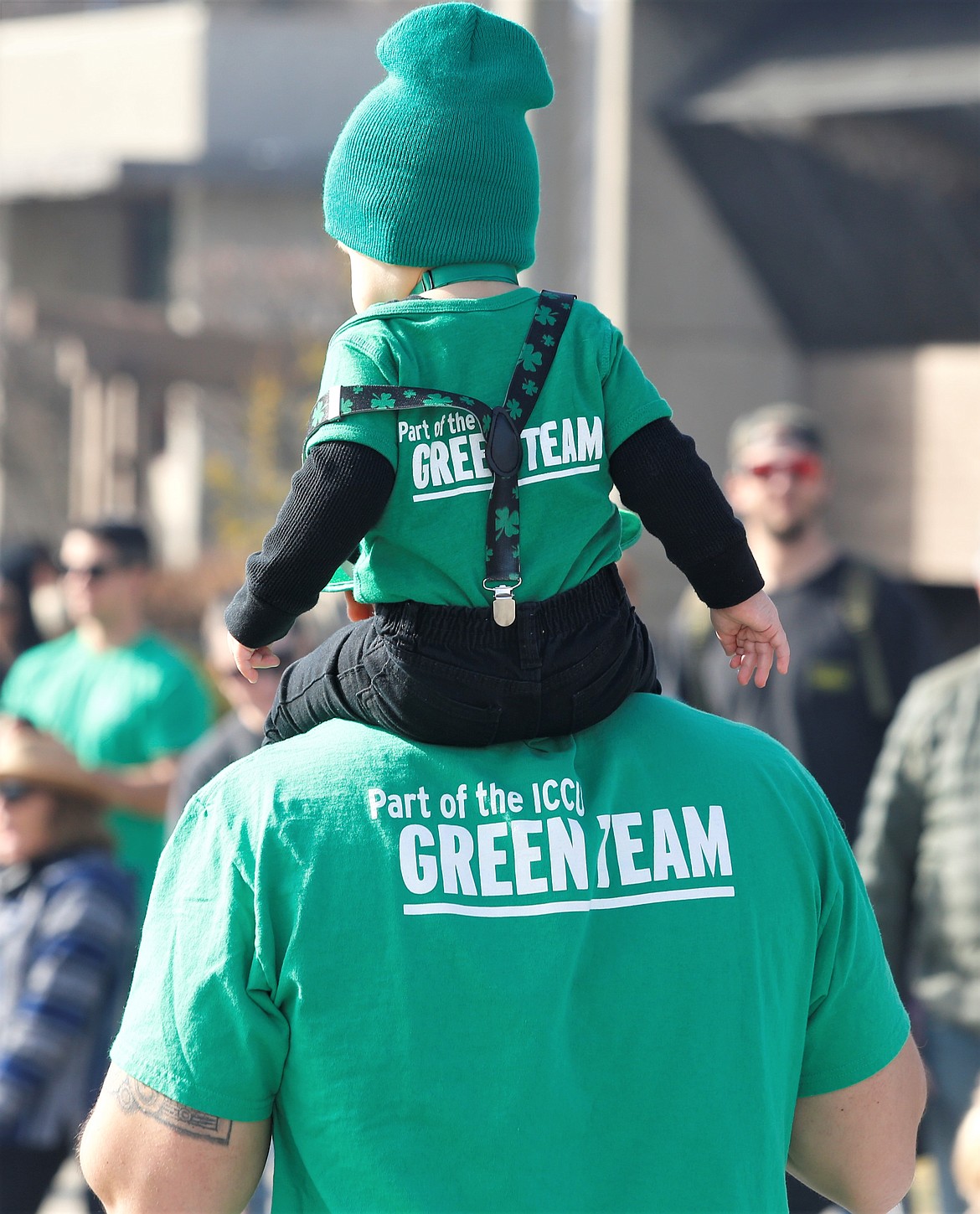 A child rides on big shoulders in the St. Patrick's Day Parade on Saturday in Coeur d'Alene.