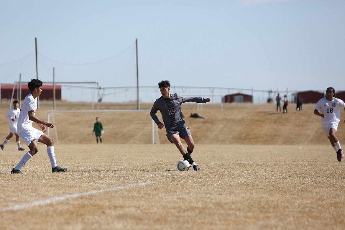 Wahluke sophomore Alex Acevedo (13) moves past an oncoming Wapato defender during the Warriors’ 1-1 draw on Saturday.