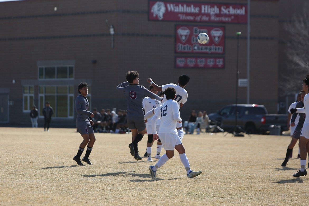 Wahluke junior Diego Olivares (9) goes up to head the ball against a Wapato defender.