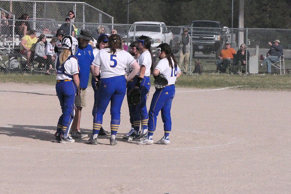 Thompson Falls' head softball coach goes over strategy during a trip to the pitching mound during last year's Lady Hawks season. (Chuck Bandel/VP-MI)