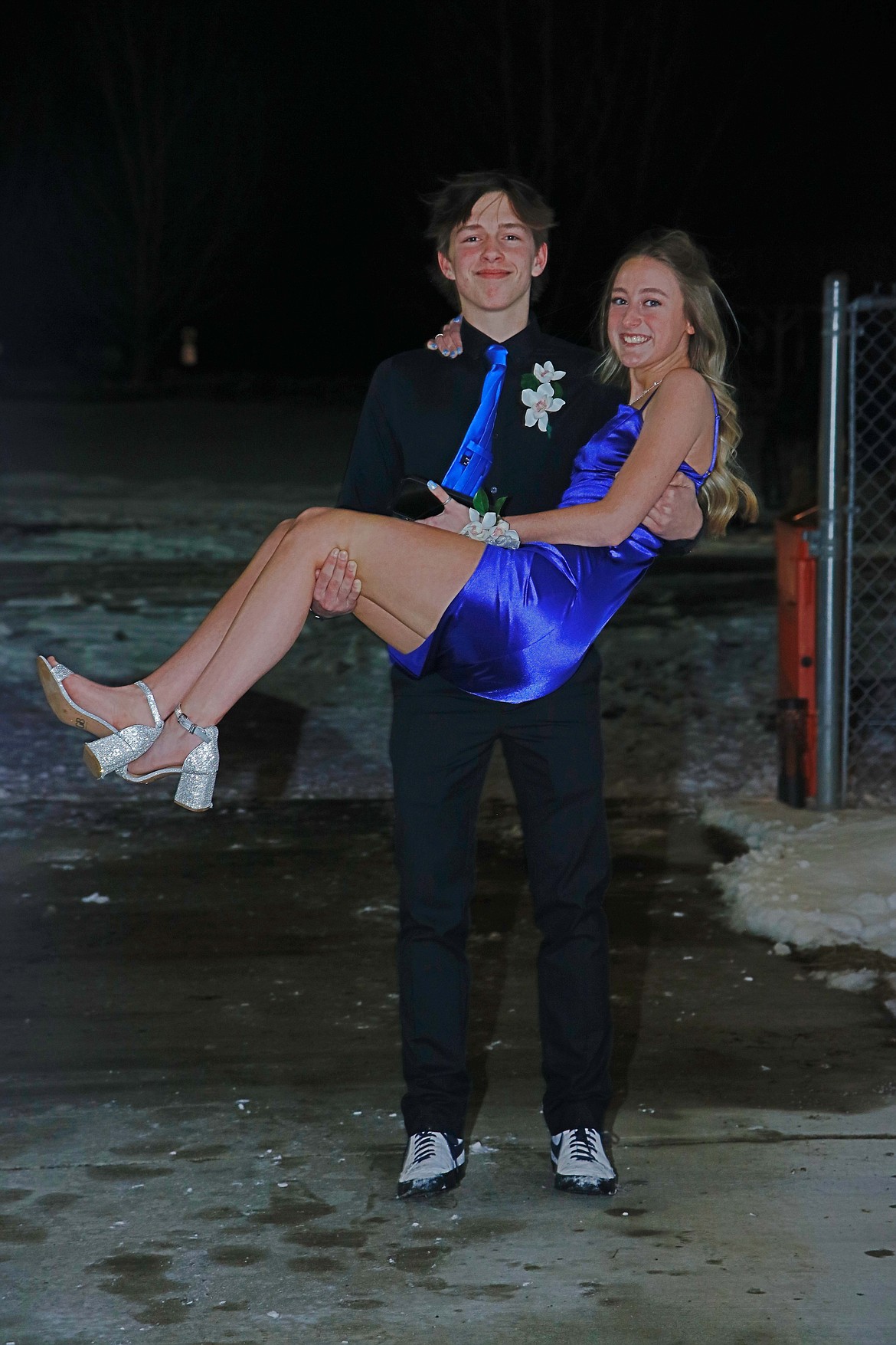 Keeping his date's shoes out of the snow, Shawn O'Keefe carries Kallen Burrows to the Plains High School prom. (Jessica Peterson photo(