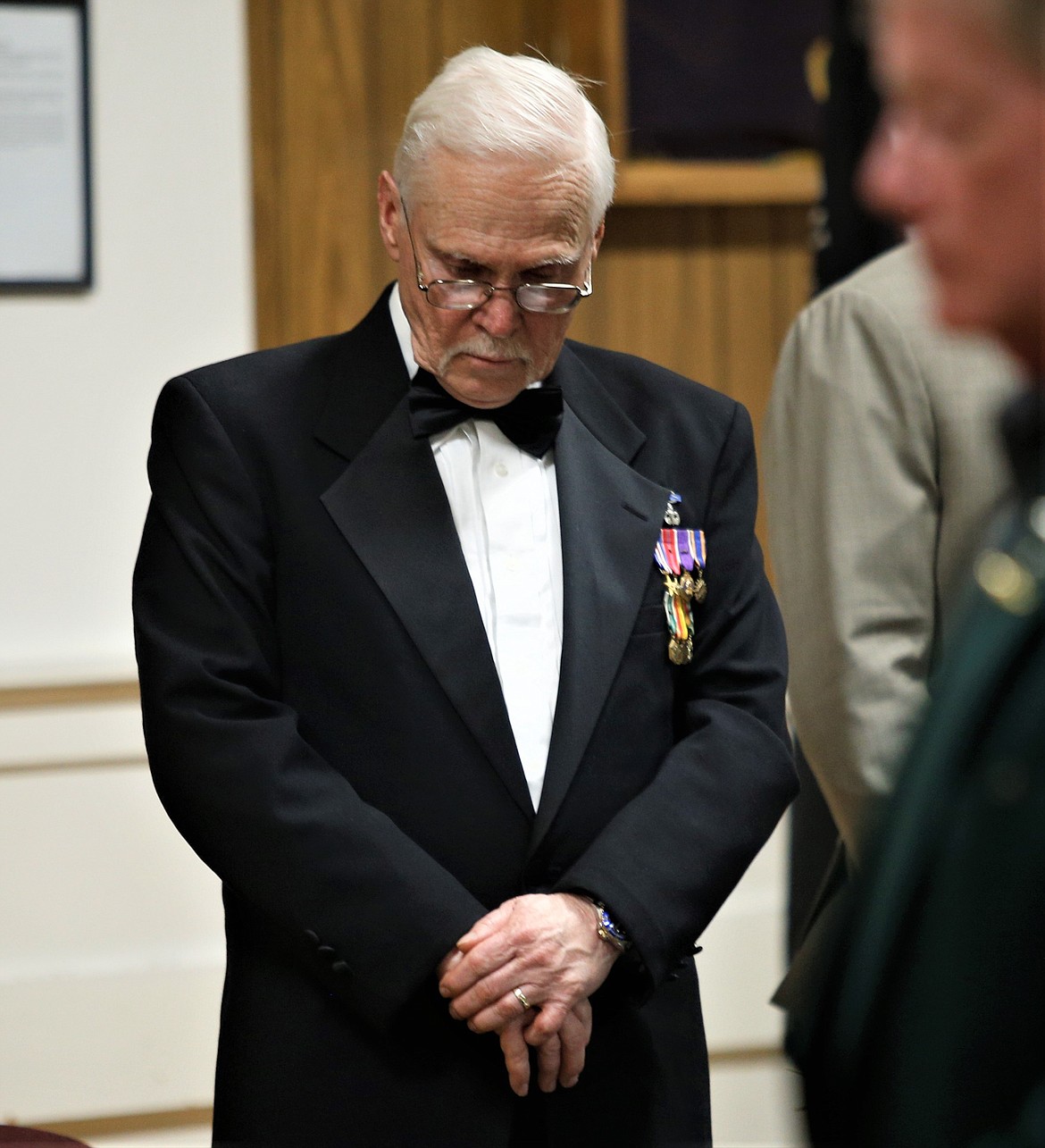 VFW 889 Commander Bob Martin bows in prayer during Saturday's dinner.