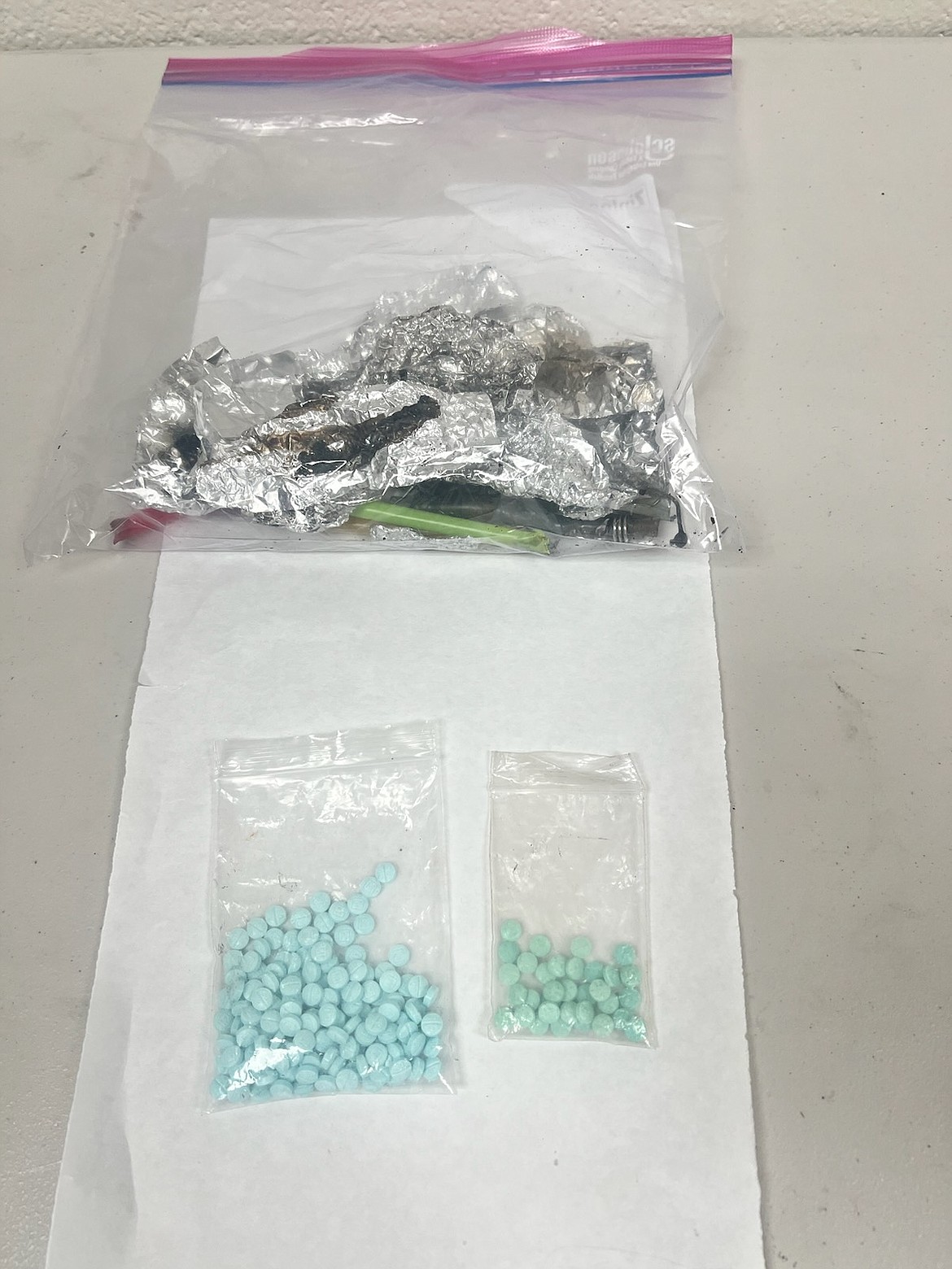 Packages of fentanyl pills confiscated by sheriff's deputies from a Spokane woman arrested Sunday in Athol.