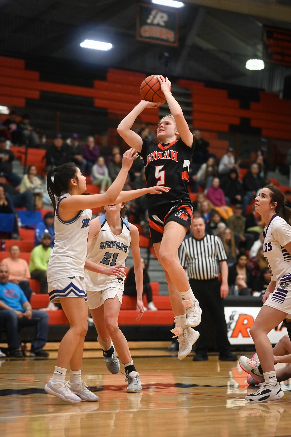 Lauryn Buhr (Ronan) goes up against Kason Page (Mission) Braeden Gunlock (Bigfork) and Hayleigh Smith (Charlo) during the Mission Valley All Stars game last Tuesday. (Christa Umphrey photo)
