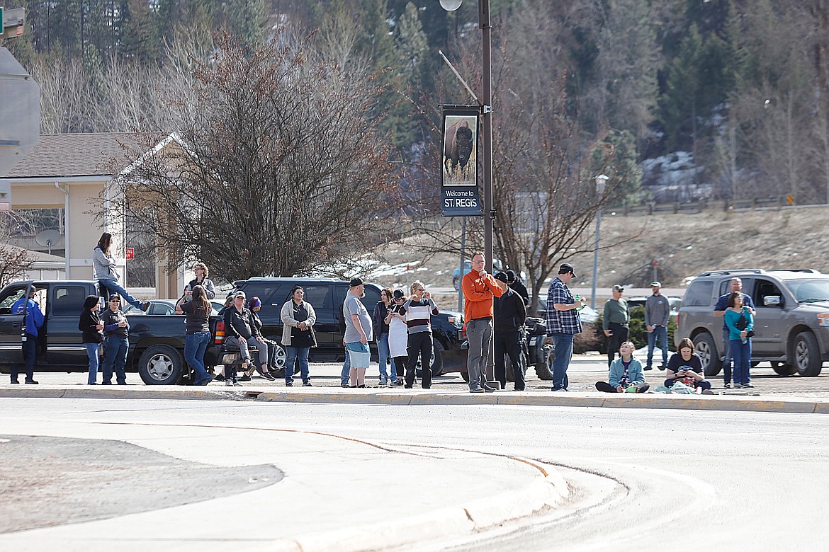 People gather near the Travel Center in St. Regis during an officer-involved shooting on Saturday. (Jessica Peterson photo)