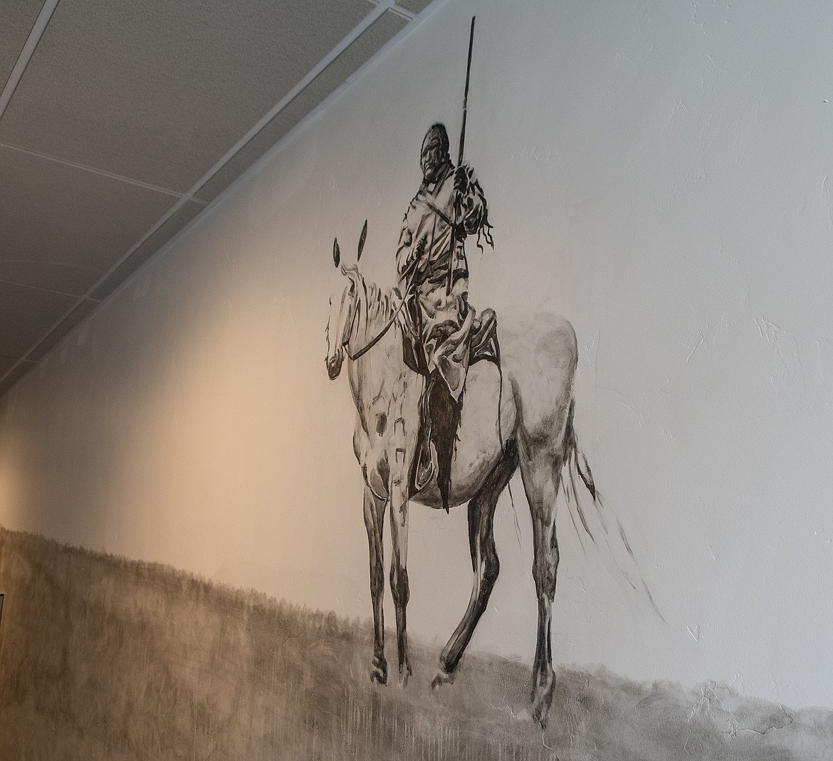 A Blackfeet hunter graces one of the hallways in a building at 540 Nucleus Avenue. (Chris Peterson photo)