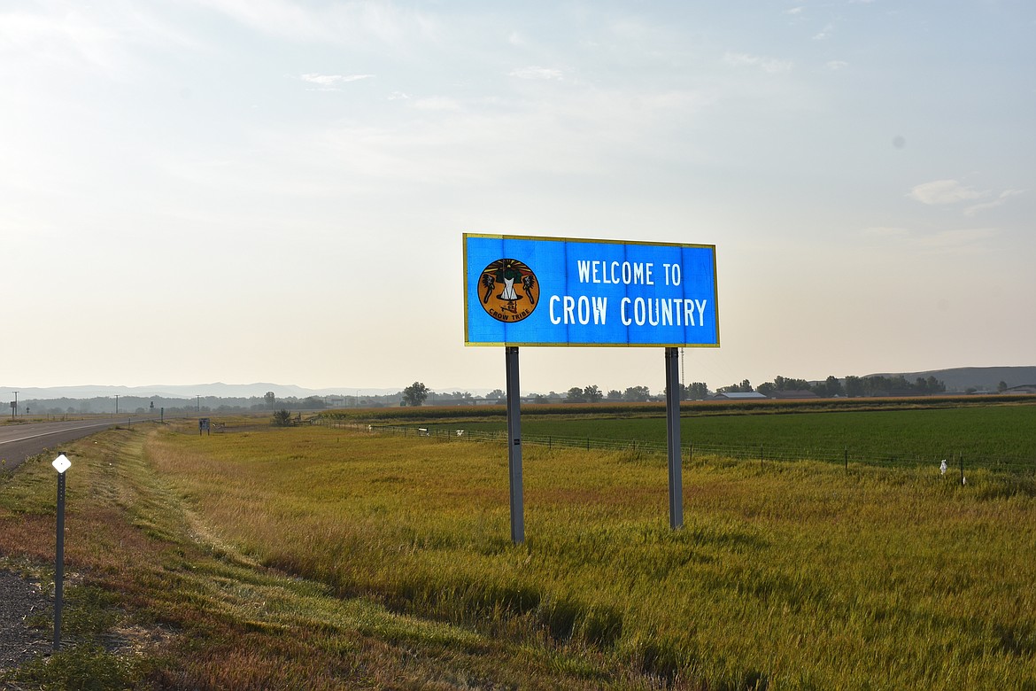 In this Aug. 26, 2020, file photo a sign marking the boundary of the Crow Indian Reservation stands near Hardin, Mont. Two women who were sentenced in tribal court and jailed on misdemeanor charges in the case of a Native American girl whose body was found in February 2021, on the Crow Indian Reservation have been named as suspects in the child’s death. (AP Photo/Matthew Brown, File)