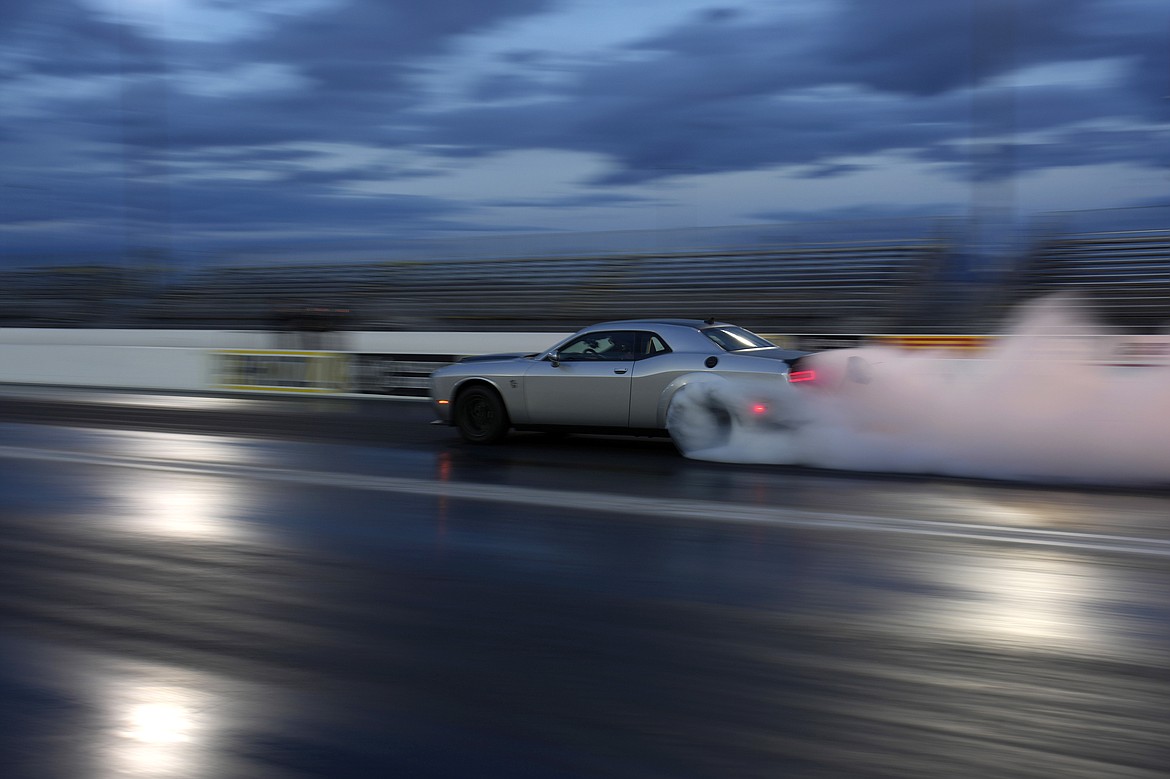 The 2023 Challenger SRT Demon 170 races down a drag strip during an event to unveil the car Monday, March 20, 2023, in Las Vegas. (AP Photo/John Locher)