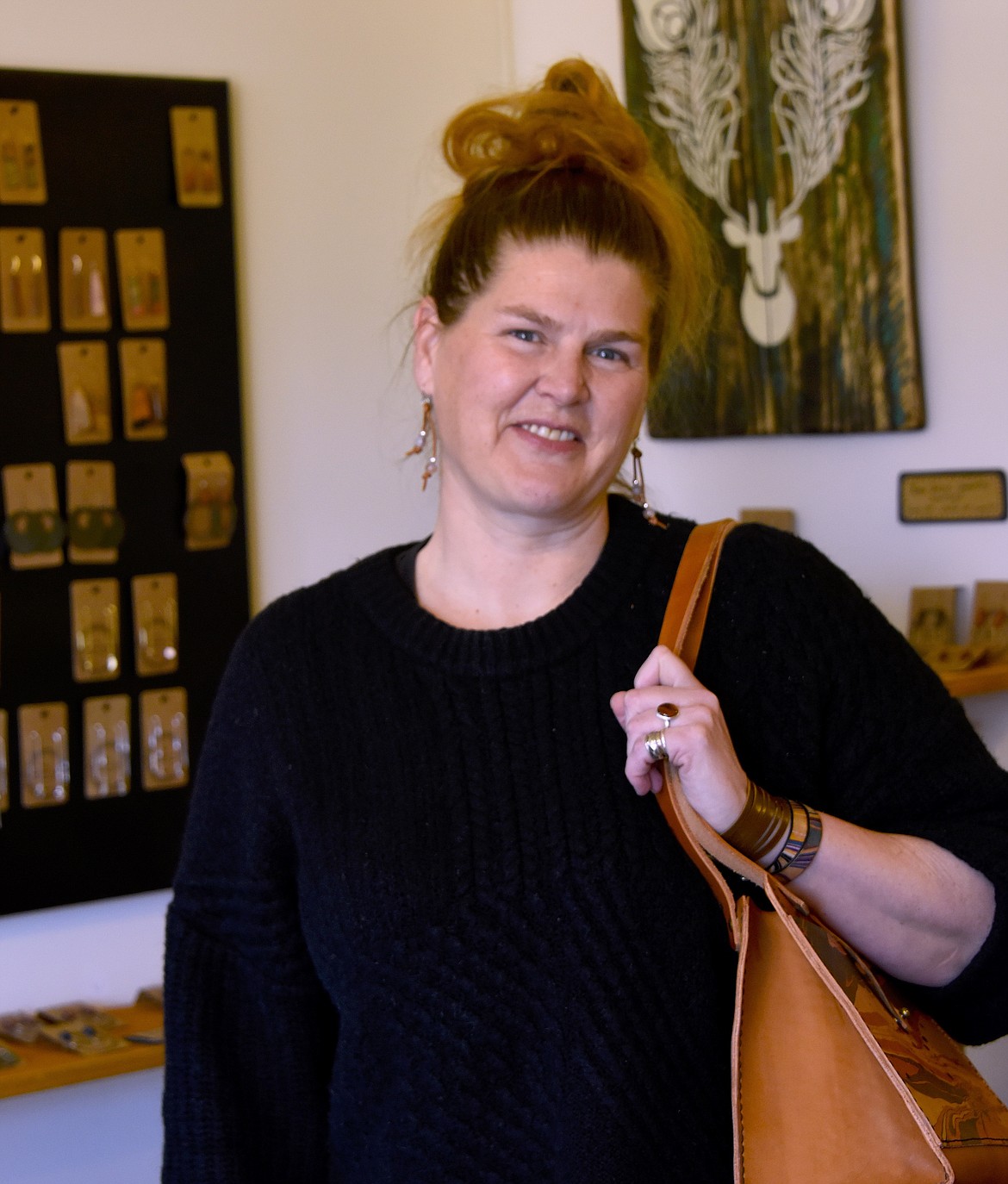 Amy McIntosh, owner of The Marbled Hide, models her handmade jewelry and bag. (Berl Tiskus/Leader)