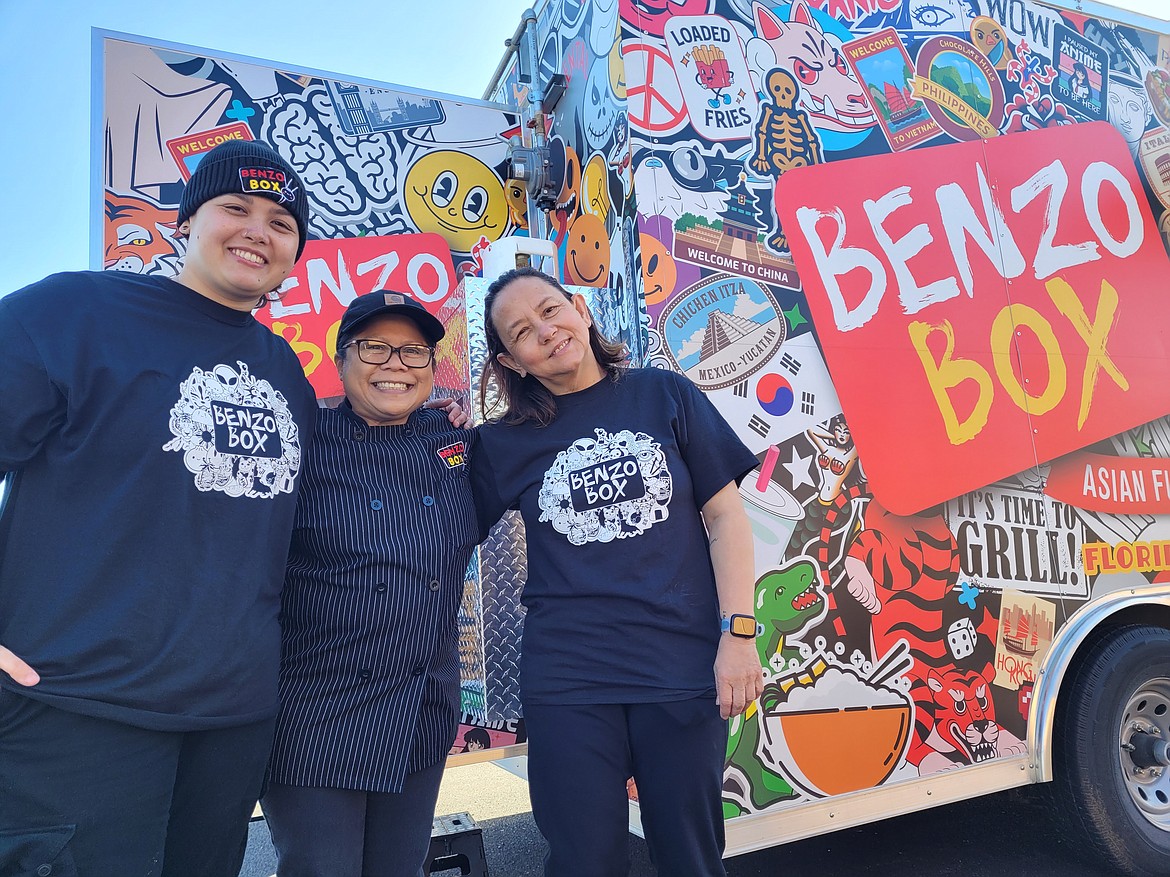 From left, Jona Wylong, Mercedes Segismundo and Madonna Mendoza smile for the camera outside of the Benzo Box food truck at the new Post Falls Pavilion on Horsehaven Avenue. The pavilion, which will feature about 20 trucks when it's fully open, had its soft opening Tuesday.