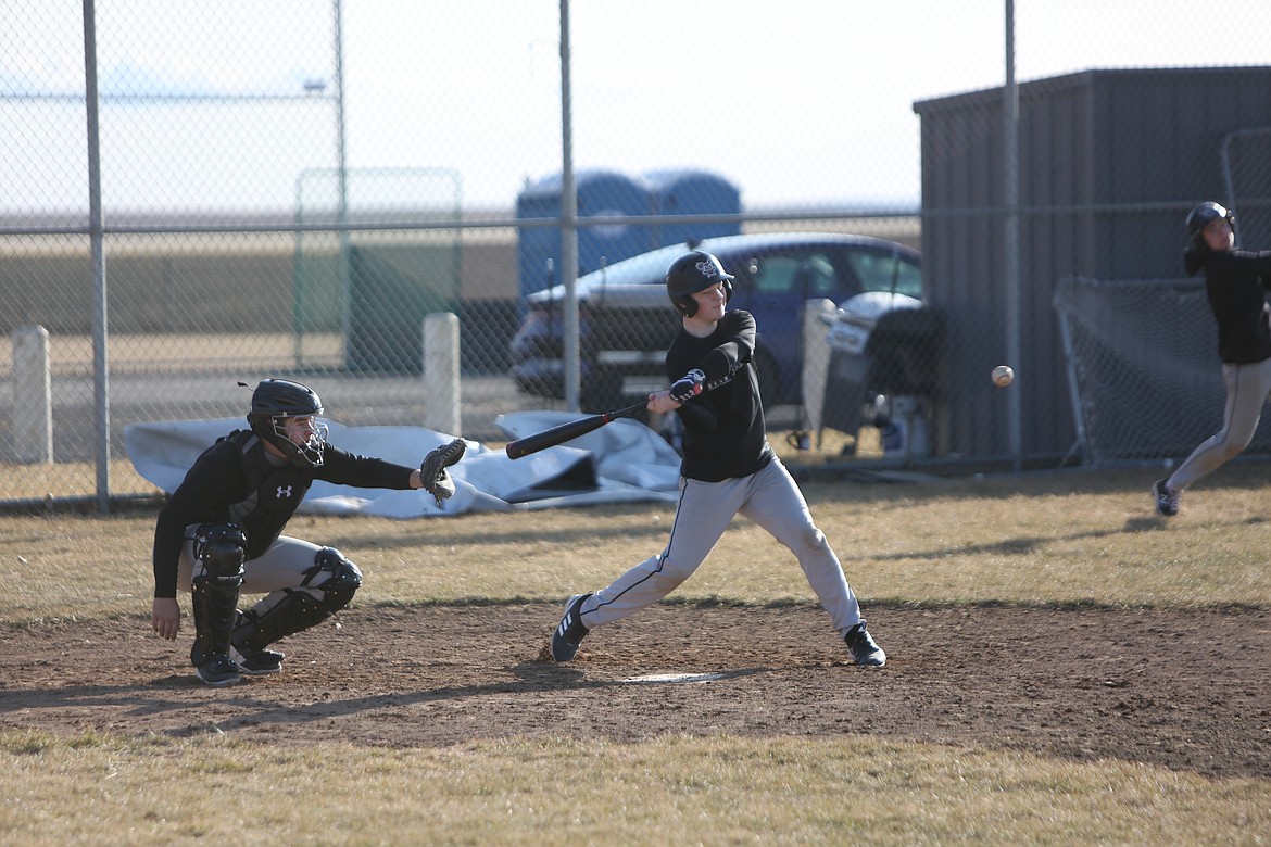 ACH sophomore Jameson Conley, right, swings at a pitch during practice.