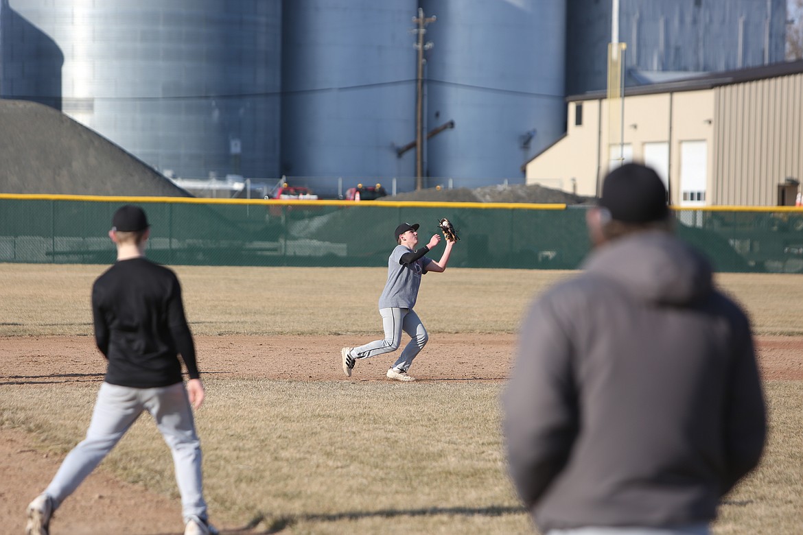 ACH sophomore Grayson Beal, in gray, catches a fly ball in the infield.