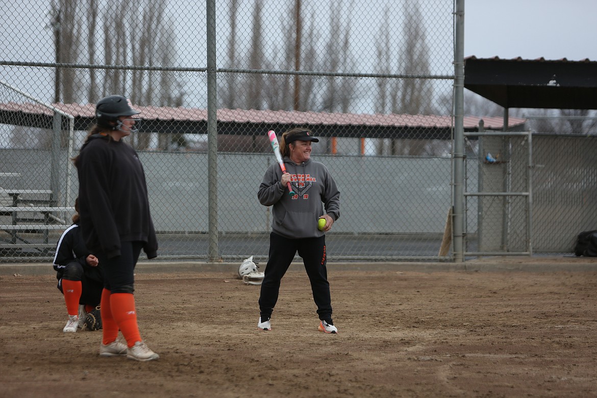 Ephrata Head Coach Heather Wood, right, bats during a Tiger practice.