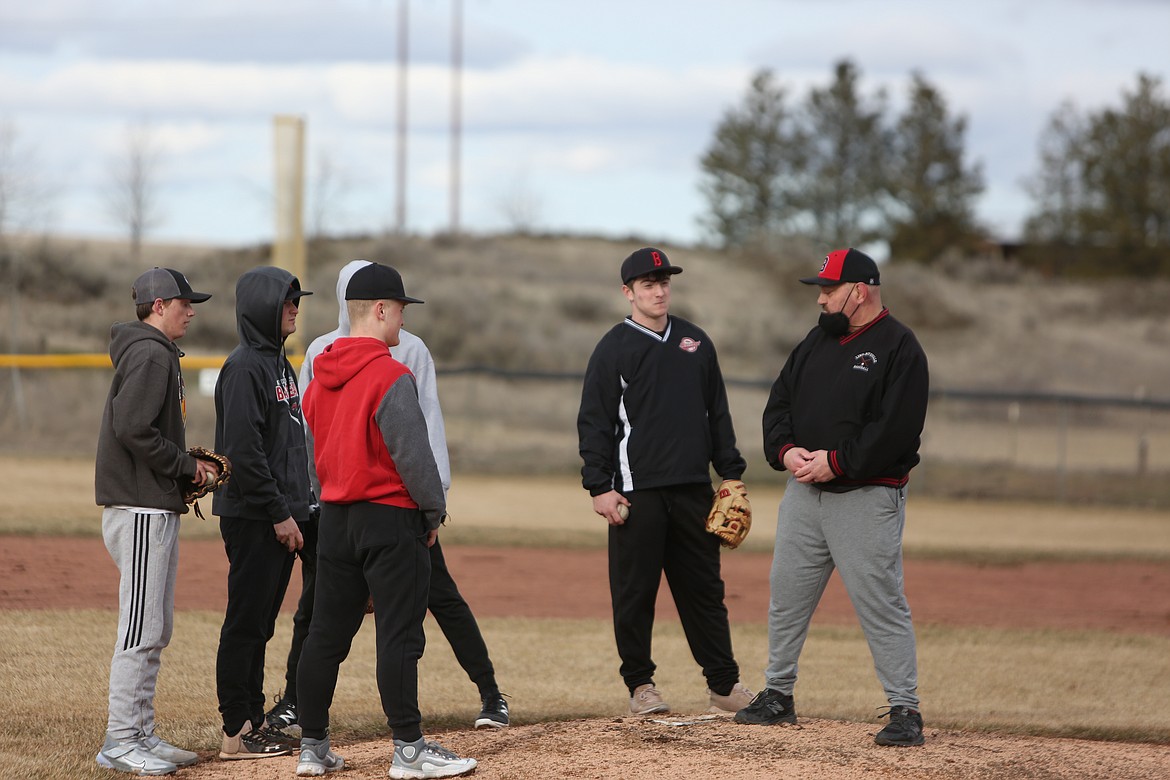 The LRS pitching staff works with Head Coach Jason Hilzer, right, on the mound during a practice.