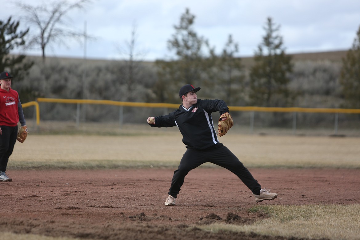 LRS sophomore Brody Boness throws to first base after fielding a ball in the infield.