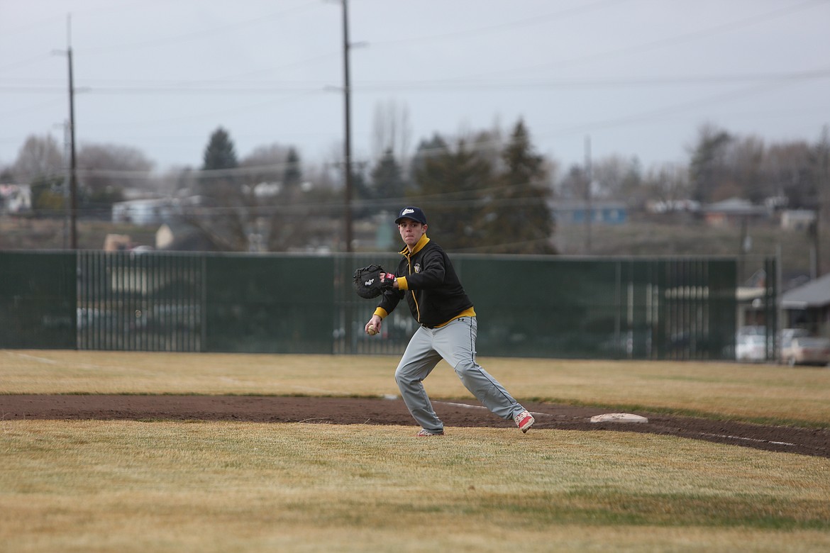 After fielding a ball, MLCA/CCS senior Ben Eldred looks to throw toward home plate.