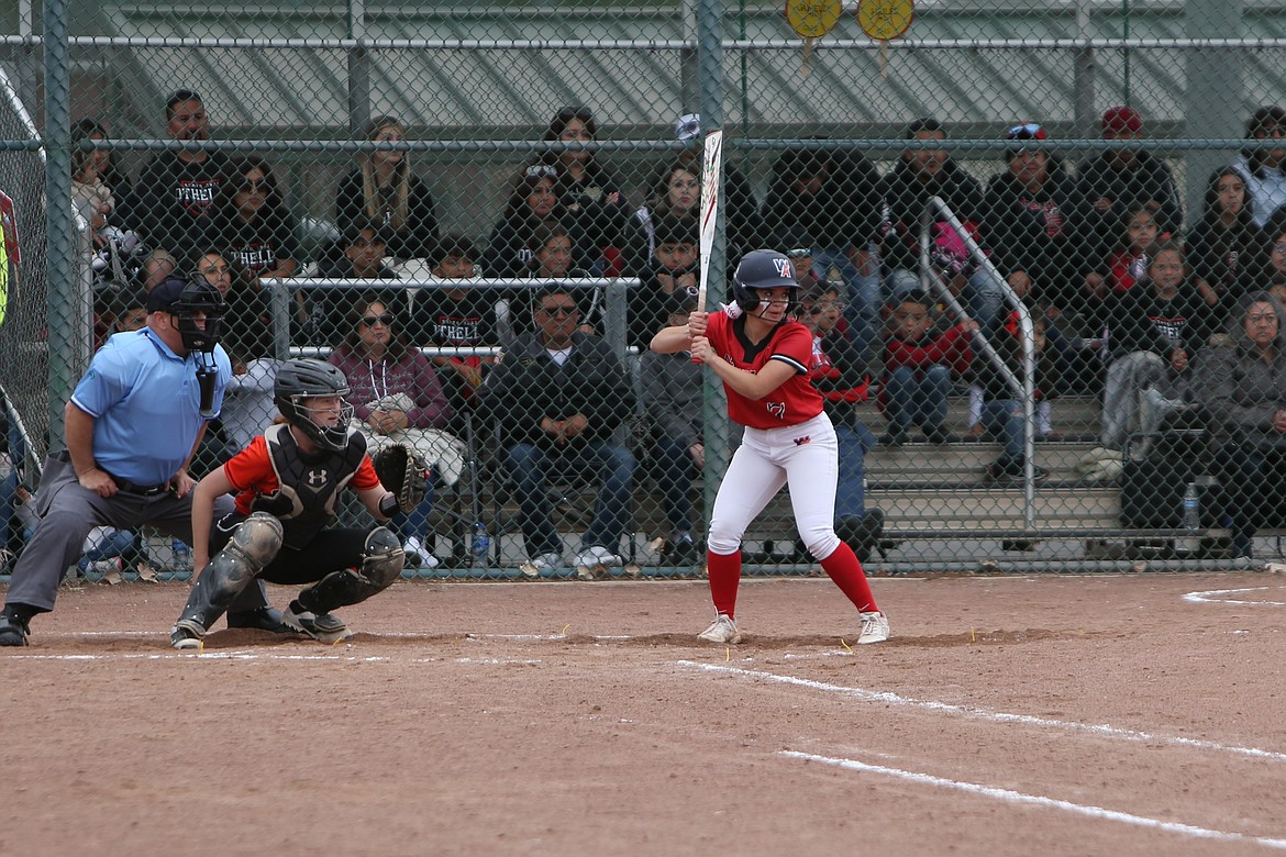 Othello junior Amarie Guzman, right, waits for a pitch in the first round of the 2022 state fastpitch tournament in Selah against West Valley (Spokane).