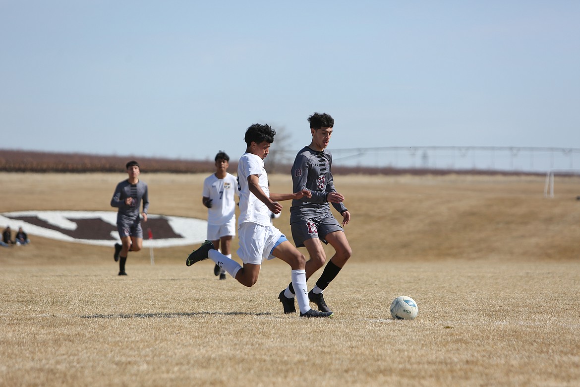 Wahluke sophomore Alex Acevedo (13) aims to get past a Wapato defender in the first half against the Wolves on March 18.