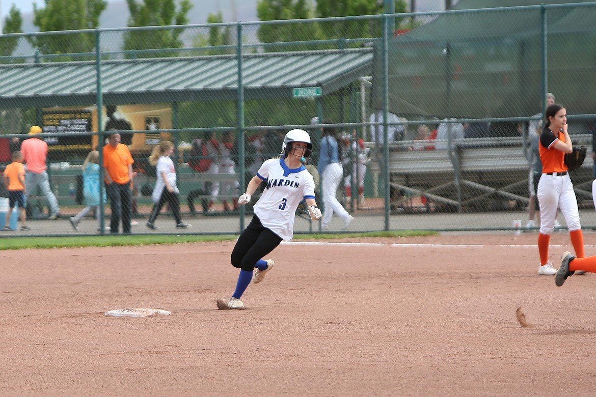 Warden junior Briannalee Martinez (3) arrives at second base during the Cougars’ state tournament game against Rainier last season.