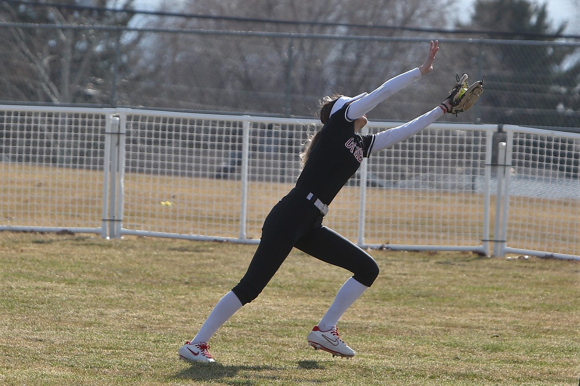 Othello junior Miccaela Valdez stretches to the side for a catch in the outfield to record an out against Shadle Park.