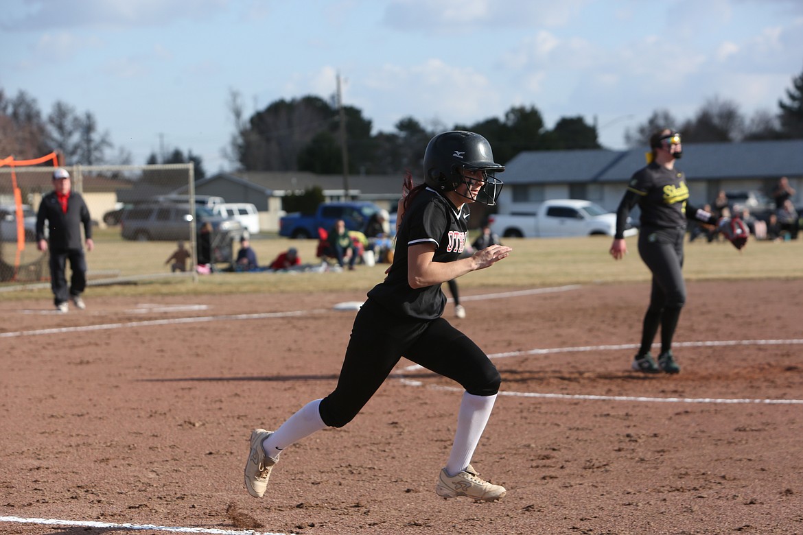 Othello junior Naraiah Benavidez-Guzman, foreground, runs to first base during the first game of the Huskies’ doubleheader against Shadle Park.