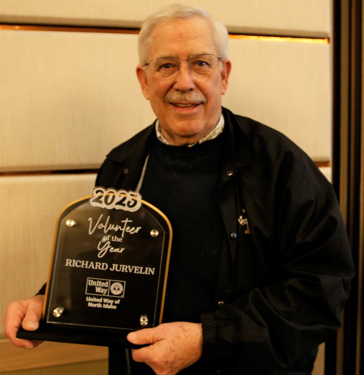 Richard Jurvelin holds the Volunteer of the Year award he received from United Way of North Idaho at The Coeur d'Alene Resort on Wednesday.