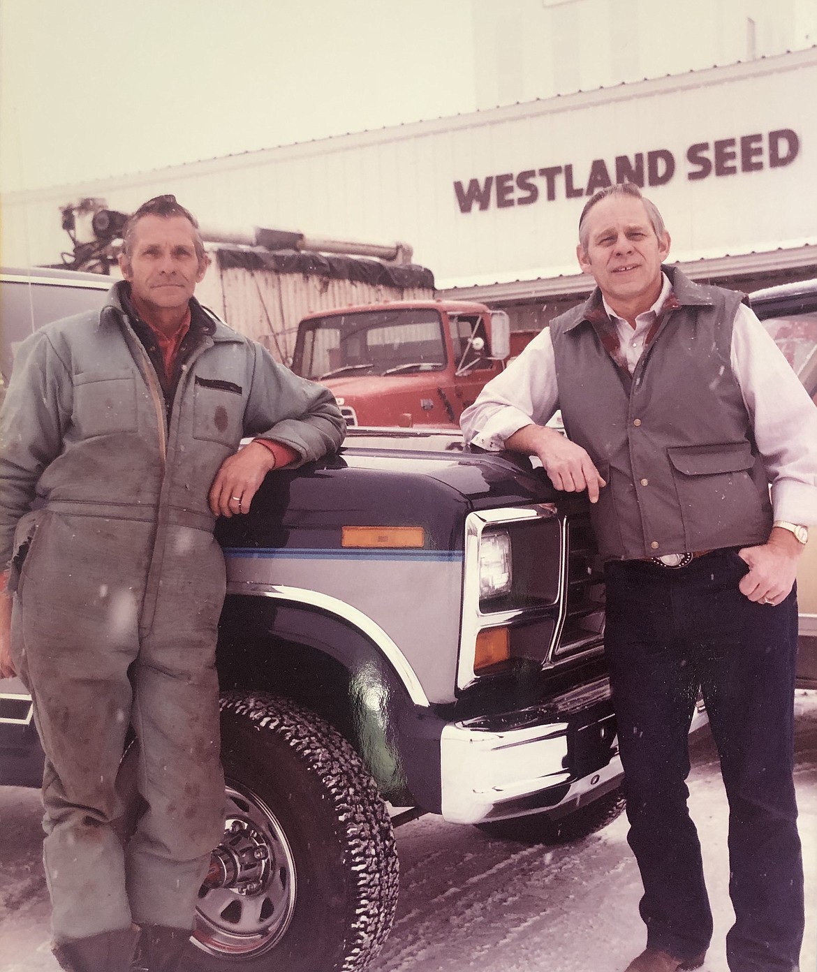 Brothers Jerry and Ken Sagmiller pose in front of the then-new Westland Seed Building in Ronan.
