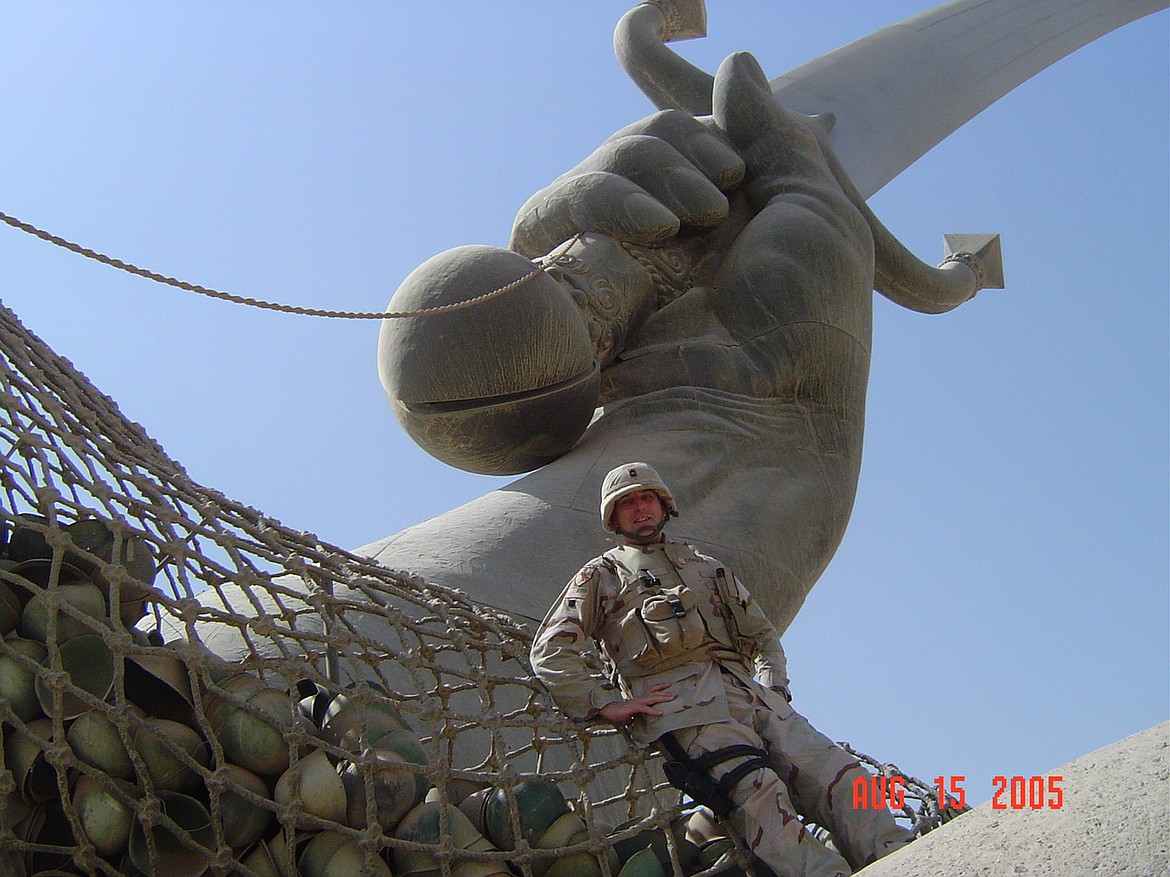 Jack Evensizer is seen Aug. 15, 2005 sitting at the base of the Hands of Victory in Baghdad, on Saddam Hussein's parade grounds.