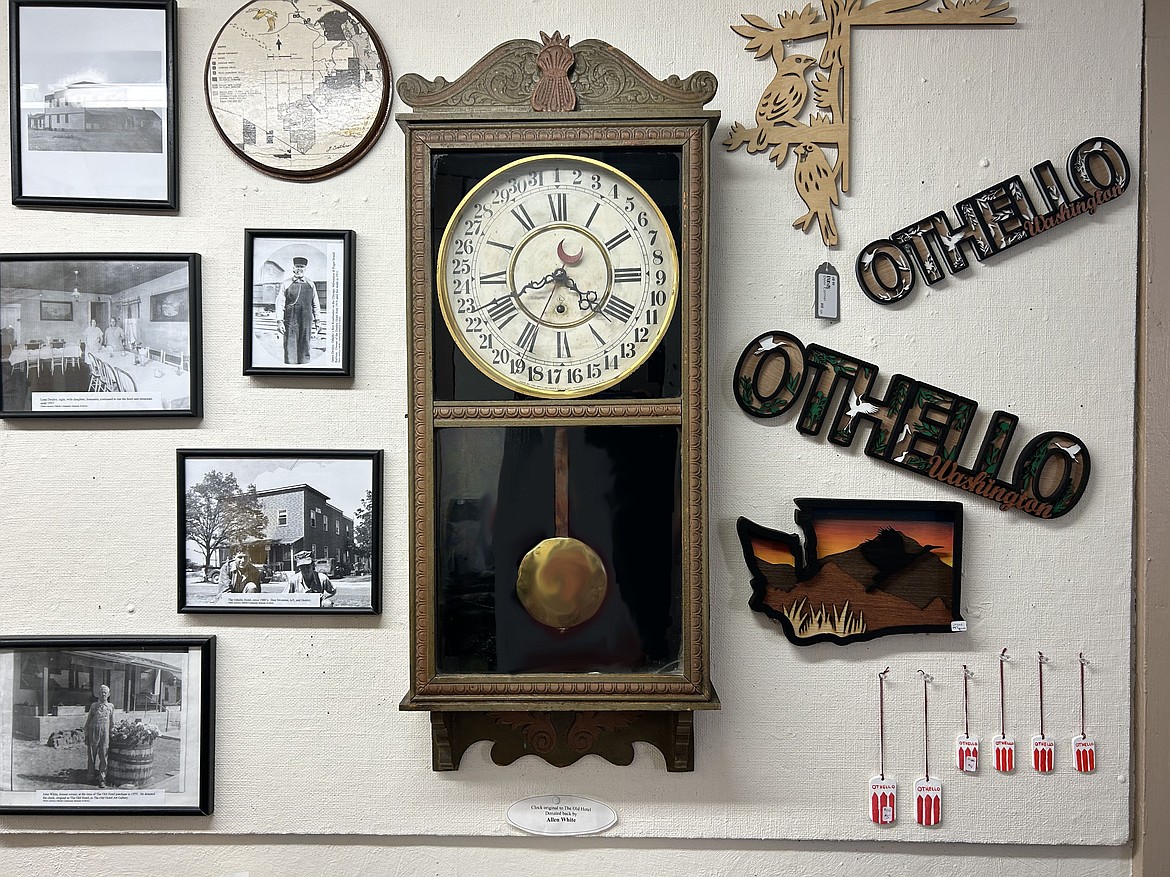 An original clock from the building that now holds the Old Hotel Art Gallery surrounded by historical photos. This clock was donated back by Allen White.