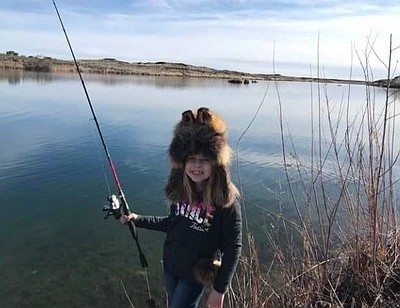 An angler drops a line in the lake at Quincy’s 2022 Trout Fishing Derby. The 2023 contest is this weekend.