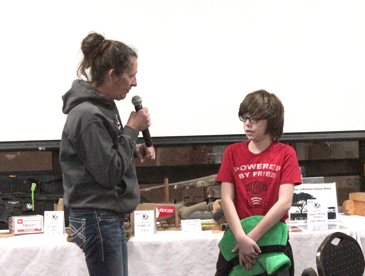 Youth Outdoors Unlimited Director Cindy Carpenter talks with 11-year-old Gavin Richards about his upcoming hunting trip.