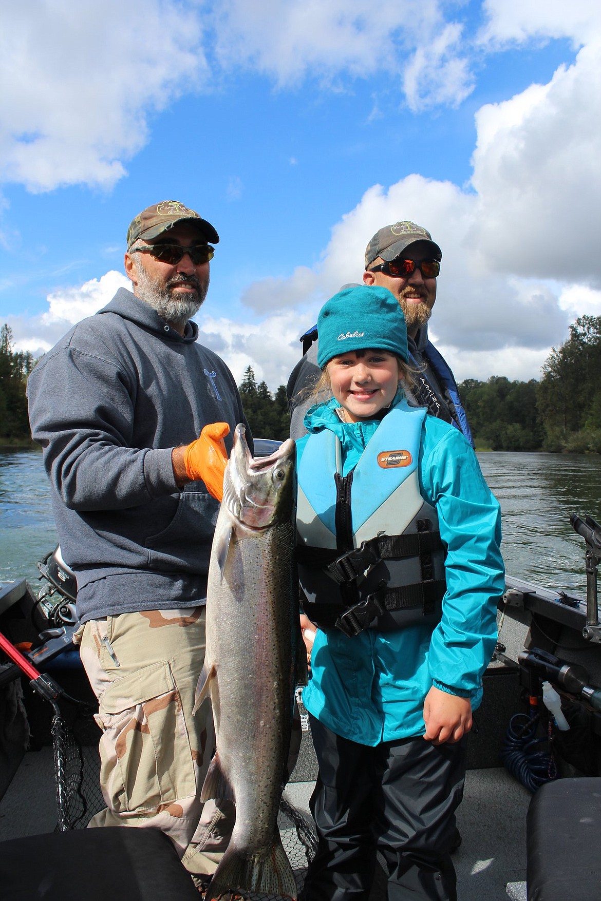 Marc Bush, left, owner of Twisted Waters Guide Service, and fishing buddy Macey Bodily, right, show off part of Macey’s catch during a fishing trip sponsored by Youth Outdoors Unlimited.