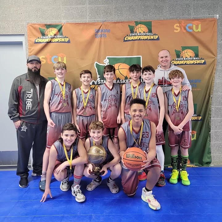 Players from the Moses Lake Tribe, a sixth-grade youth basketball team, smile for photos after winning a state tournament in Spokane last weekend.