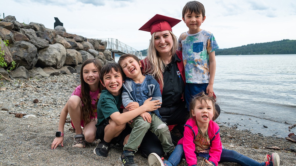 NIC Diesel Technology alumna Melanie Andrews poses with her children during a graduation photo shoot organized by the college’s Center for New Directions in May 2022 at Sunspot at Yap-Keehn-Um Beach near NIC’s campus in Coeur d’Alene.