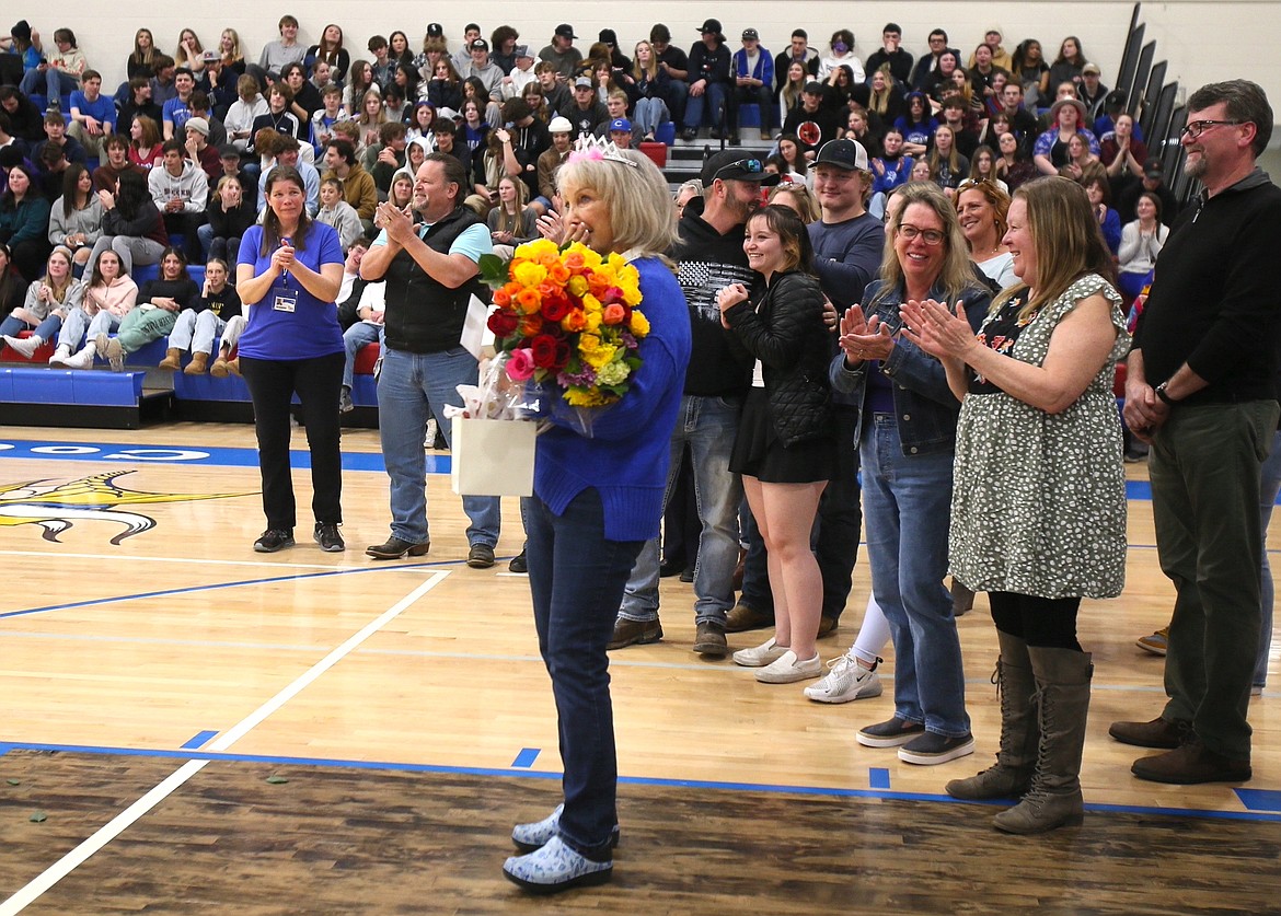 Eileen Bieber, wearing a tiara placed on her head by longtime friend Melody Melton, is surprised by the outpouring of love and flowers from former students as she is celebrated Friday for her contributions to Coeur d'Alene High over the past 50 years.