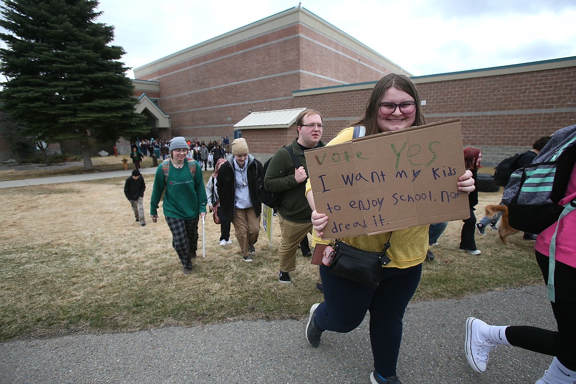 Senior Piper Benzon carries a sign as she and her classmates walk out of school Friday to rally in response to Coeur d'Alene School District's supplemental levy failing for the first time since 1986.