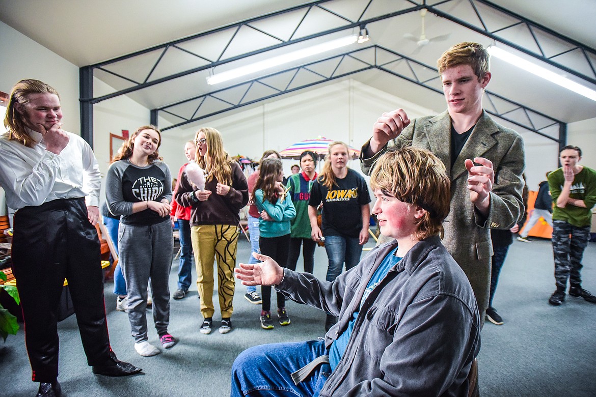 Nathan Kauffman, at left, as The Child Catcher, Ethan Kauffman as Sidney, seated, Jarom Holcomb as Caractacus Potts and fellow castmates perform a scene as the Homeschool Theater Club practices their performance of Chitty Chitty Bang Bang on Friday, March 24. (Casey Kreider/Daily Inter Lake)