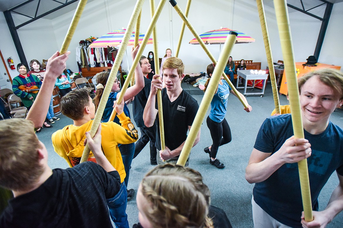 Jarom Holcomb as Caractacus Potts, center, and fellow castmates peform a scene as the Homeschool Theater Club practices their performance of Chitty Chitty Bang Bang on Friday, March 24. (Casey Kreider/Daily Inter Lake)