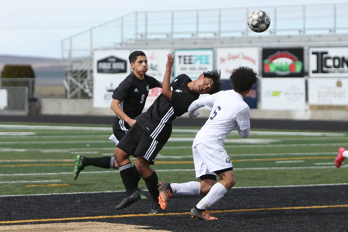 Royal sophomore Victor Aquino attempts to head the ball in for a goal during the first half against College Place.