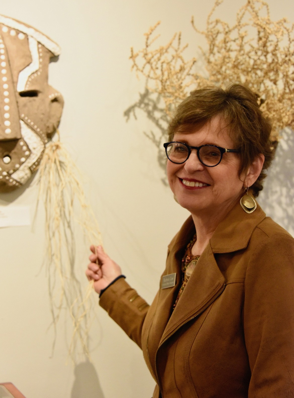 Guest Artist Barbara Liss, Hamilton, discusses her concrete sculpture pieces at the Sandpiper Art Gallery and Gifts' "Last Best Place" show during the reception on March 24. (Berl Tiskus/Leader)