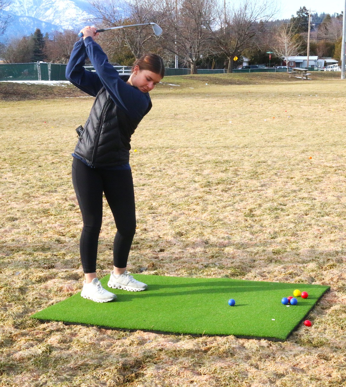 Avery Bayer works on golf swing at practice.