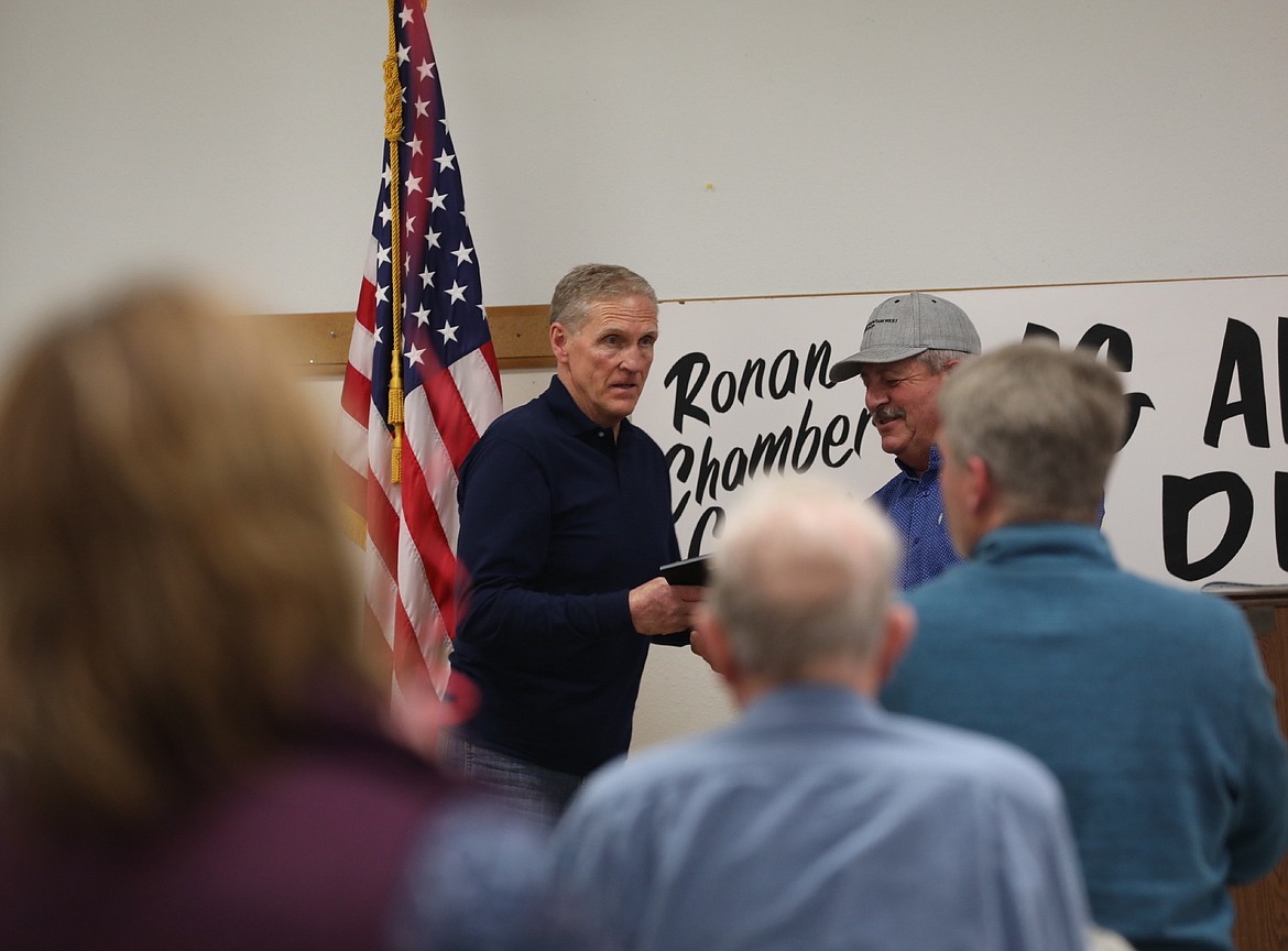 Jack Stivers gets a standing ovation as Ken McAlpin presents him with the Ronan Chamber of Commerce's Ag Advocate of the Year award . (Susan Lake/Leader)